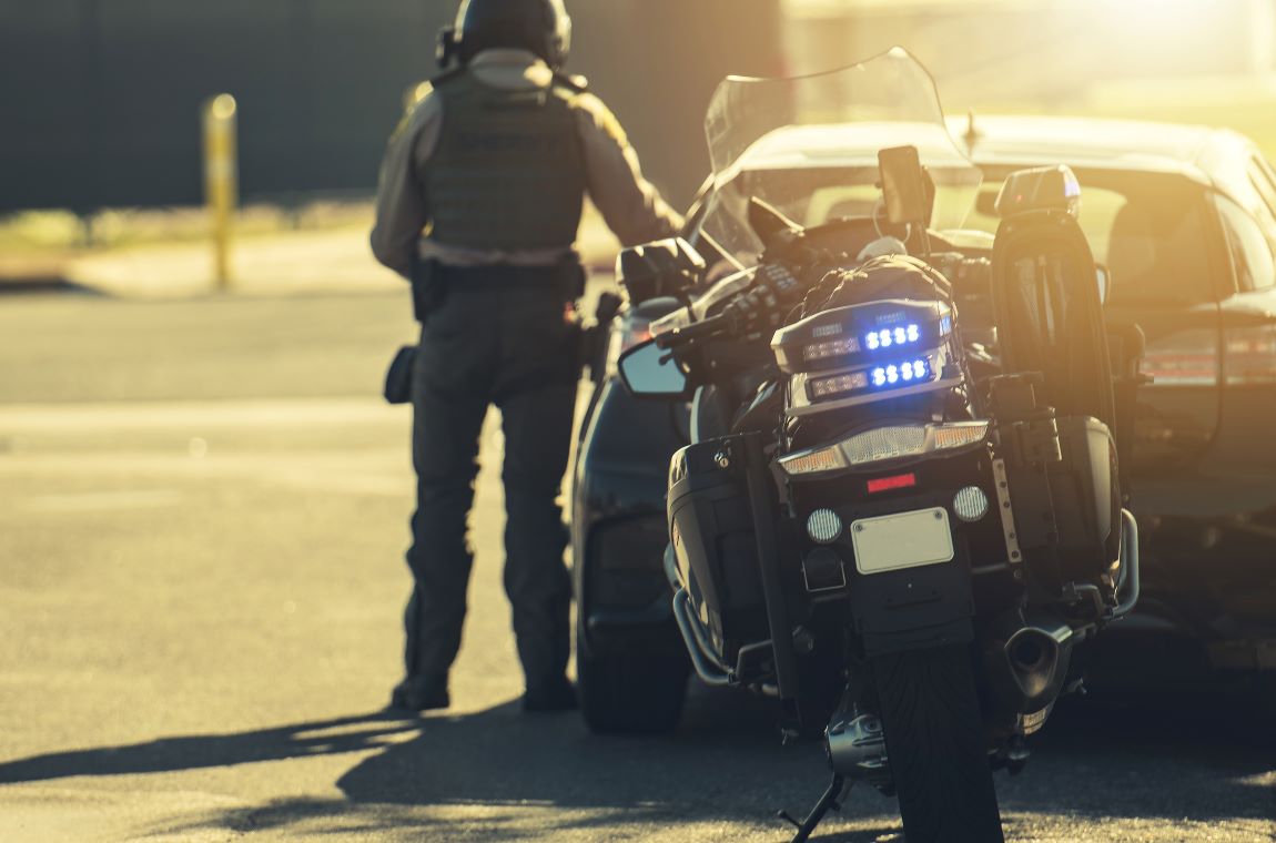 motorcycle police officer giving traffic ticket